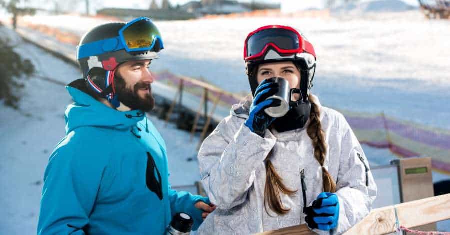 snowboarder and skier drinking snowboarder and skier drinking